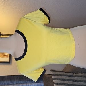 Lg but fits like a MED. yellow crop top w/black at hem of sleeves and neckline.